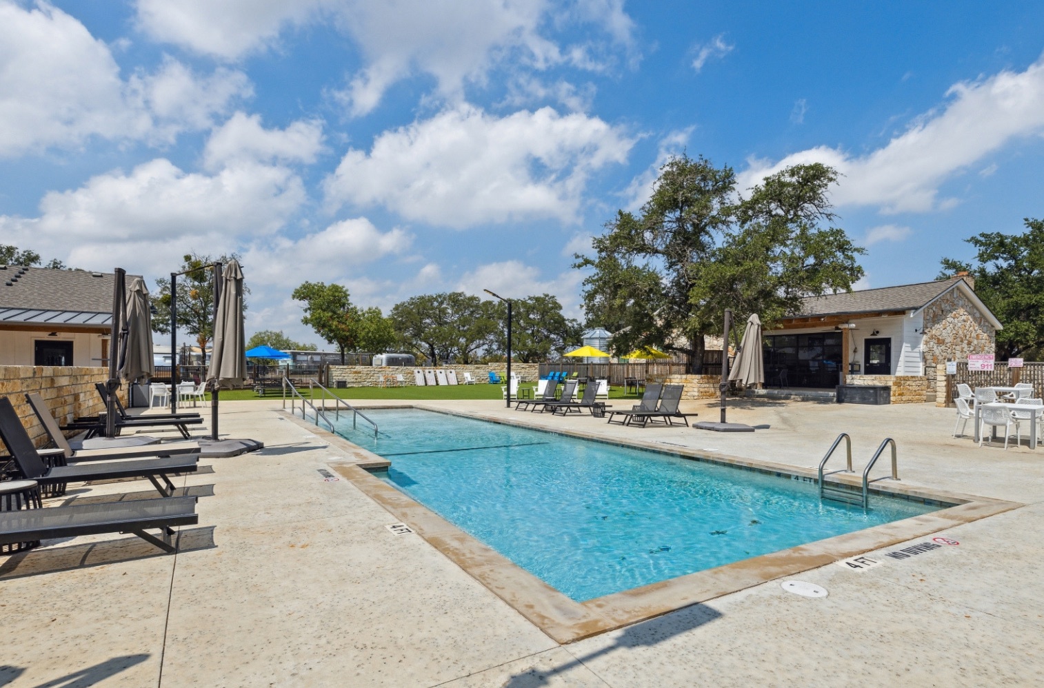 Existing swimming pool and limestone community buildings at Open Air Spicewood
